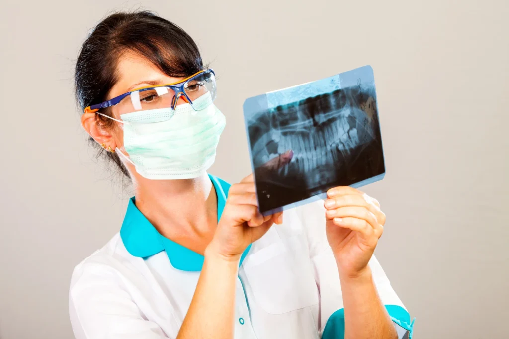 dentist looking at xray for dentures made in Imperial Courts Clearwater
