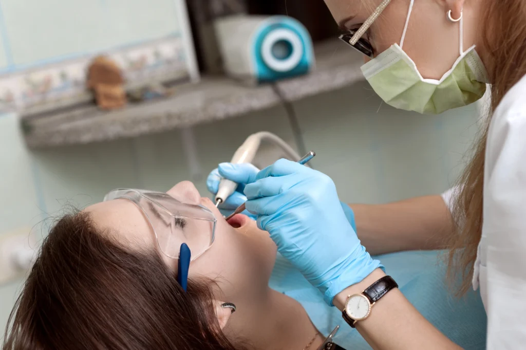 woman at the dentist receiving root canal in st petersburg